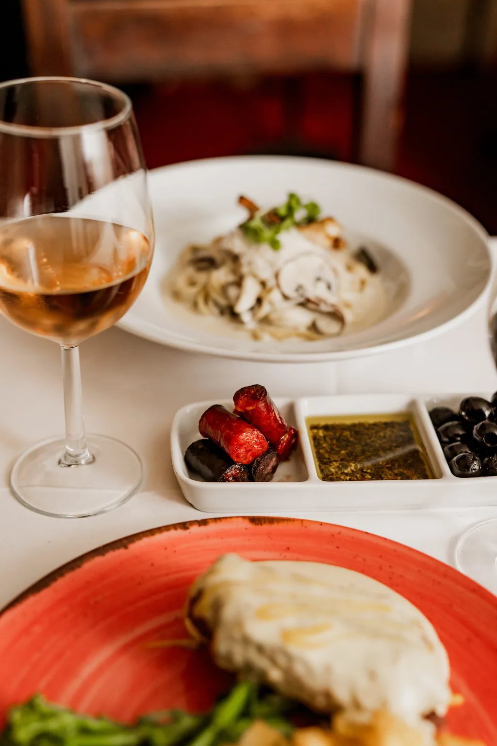 Tisch mit Weißwein, Vorspeisen und Oliven